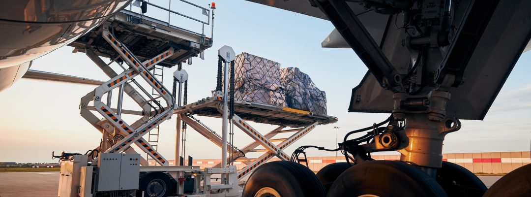 Loading of cargo containers to plane at airport